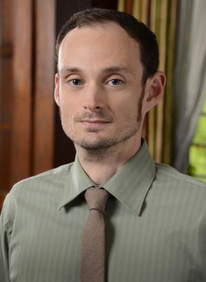 Man in shirt and tie in front of a window