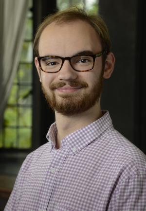 manin plaid shirt with glasses in front of a window